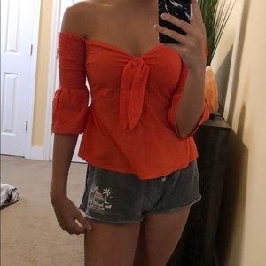 bright orange off the shoulder top